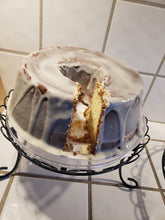 Load image into Gallery viewer, This delicious pound cake is made with cream cheese, butter, and a blend of tasty ingredients. Comes with or without a mouth-watering glaze.
